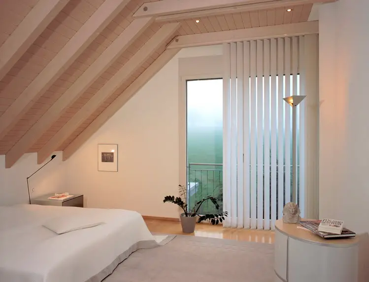 vertical blinds in attic bedroom