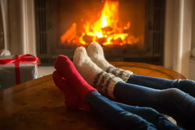 winter night socks in feet by fireplace