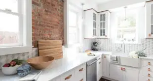white cabinets with brick wall