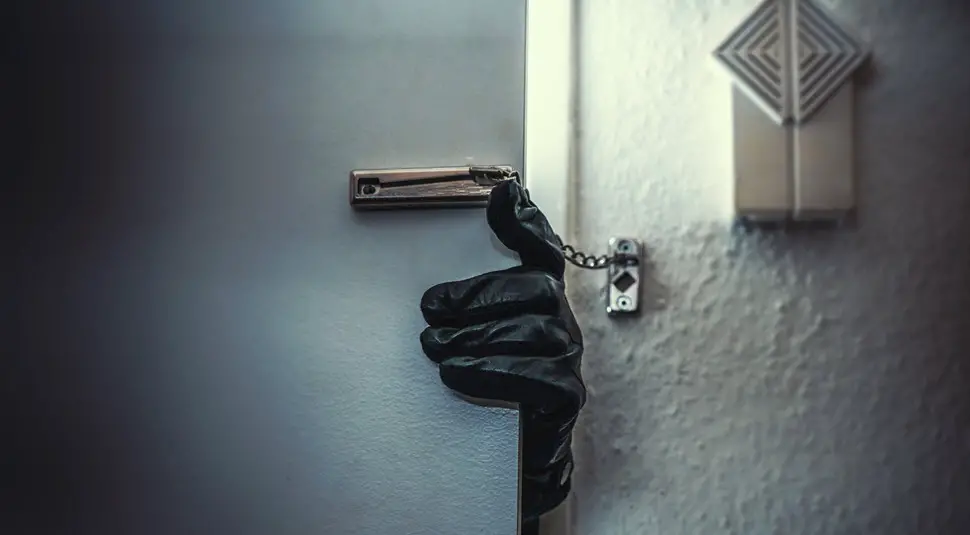 burglar hand trying to break in through door