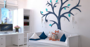 childrens bedroom white with blue tree on wall and blue pillows and ornage plush foxes